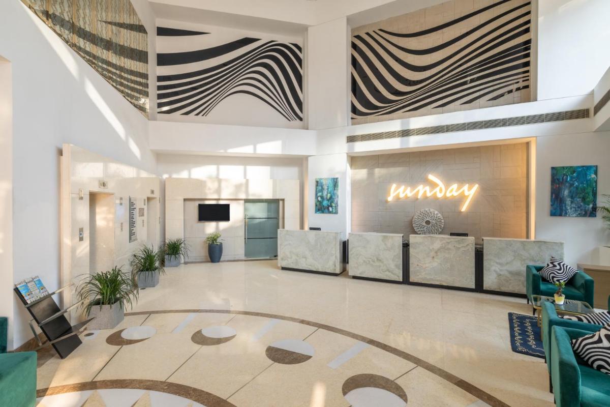 a lobby with couches and a sign that reads mummy at Sunday Hotel Jaipur in Jaipur