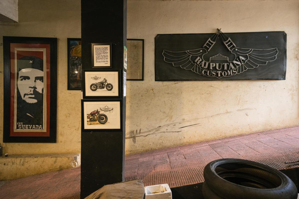 a room with posters on the wall and a toilet at Sunday Hotel Jaipur in Jaipur