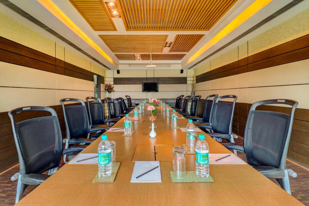 a conference room with a long table with water bottles on it at Sunday Hotel Jaipur in Jaipur