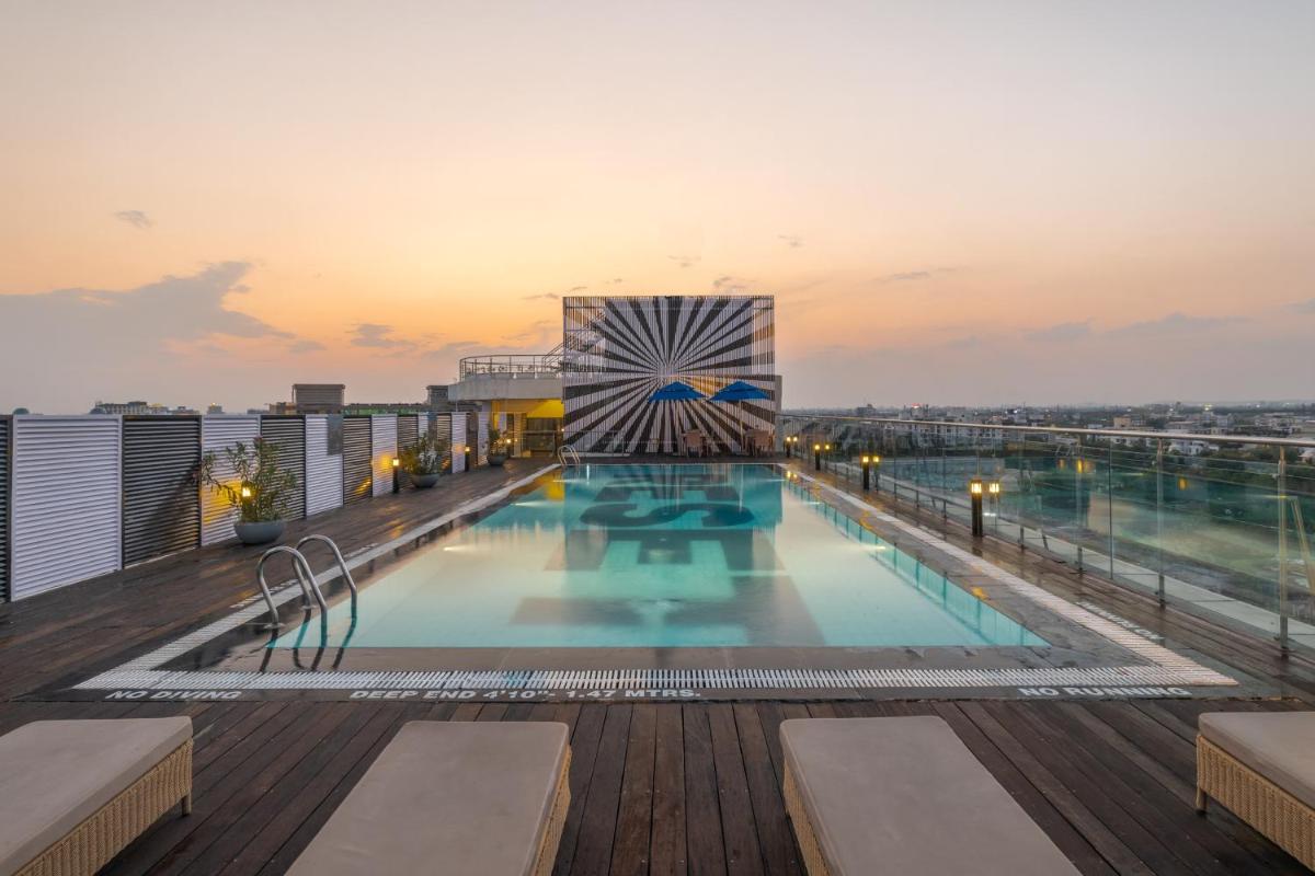 a swimming pool on the roof of a building at Sunday Hotel Jaipur in Jaipur