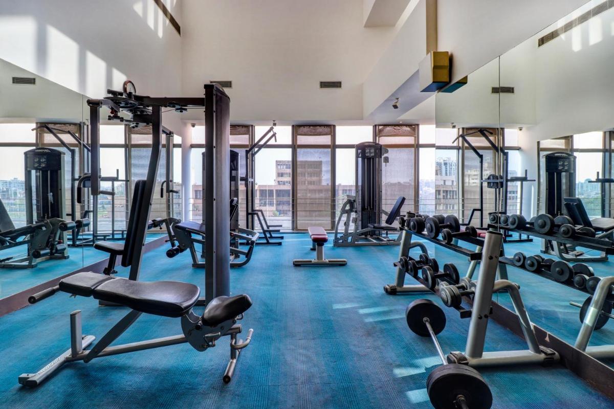 a gym with cardio equipment and treadmills at Sunday Hotel Jaipur in Jaipur
