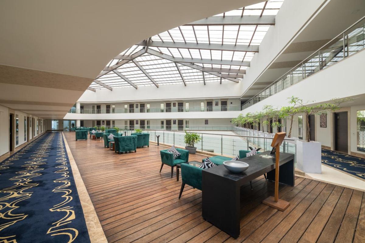 a large room with tables and chairs in a building at Sunday Hotel Jaipur in Jaipur
