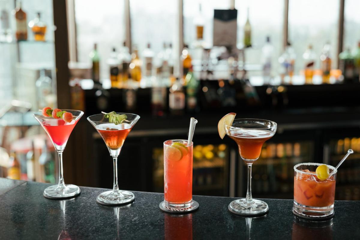 a group of four cocktails sitting on a bar at Sunday Hotel Jaipur in Jaipur