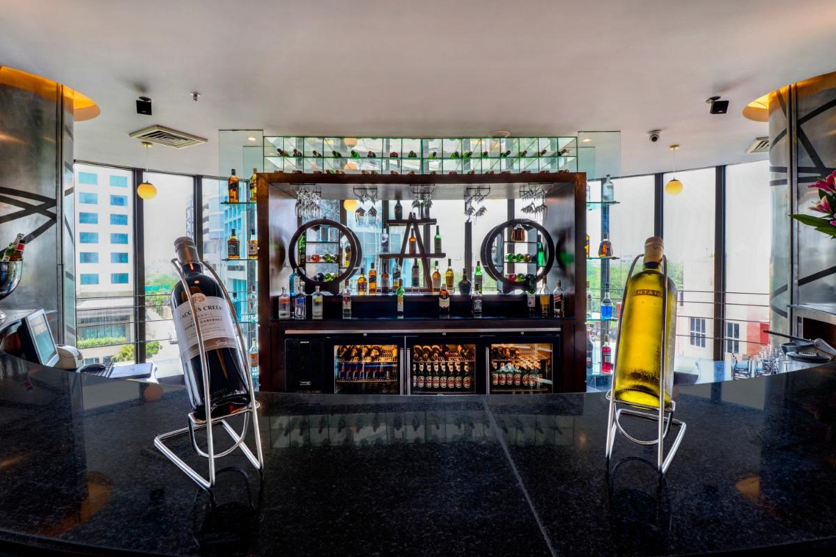 a bar with two bottles of wine on a counter at Sunday Hotel Jaipur in Jaipur