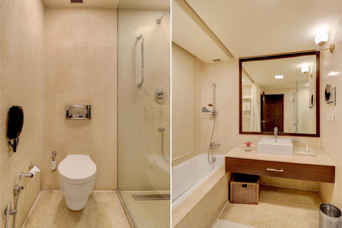a bathroom with a toilet and a sink and a shower at Sunday Hotel Jaipur in Jaipur