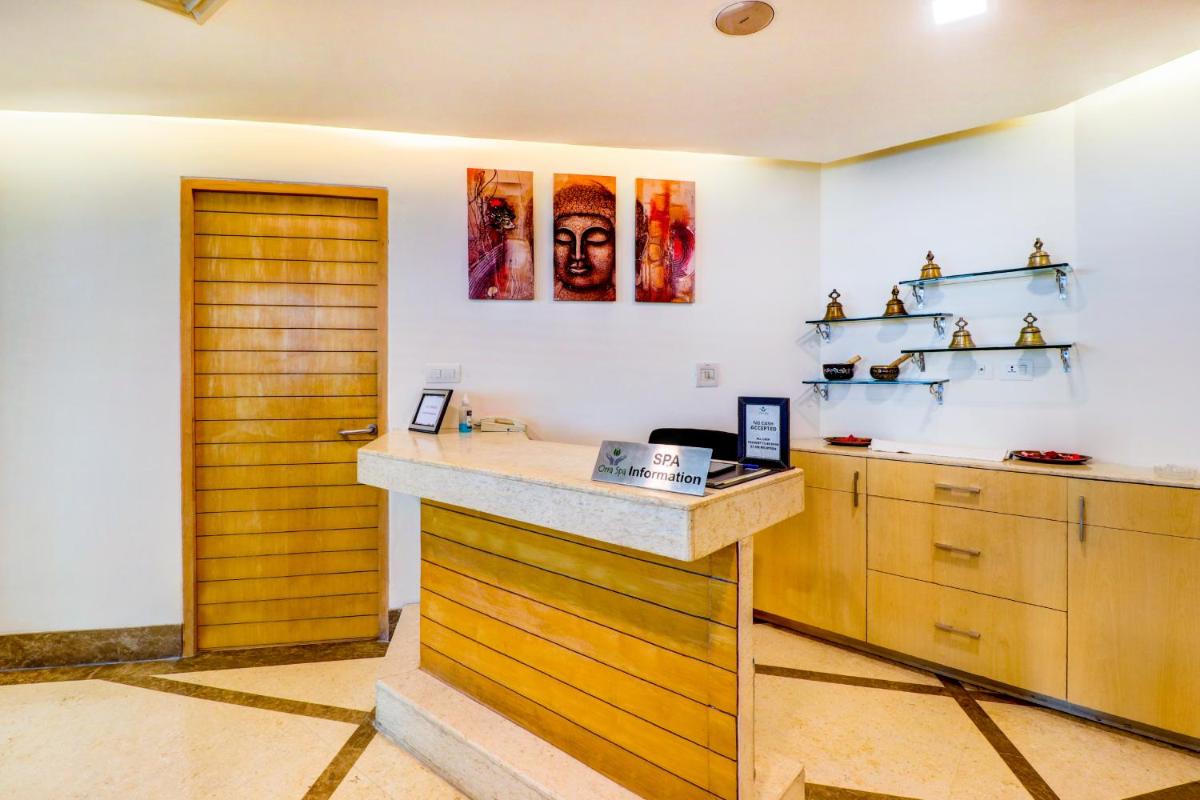 a kitchen with a counter and a wooden door at Sunday Hotel Jaipur in Jaipur