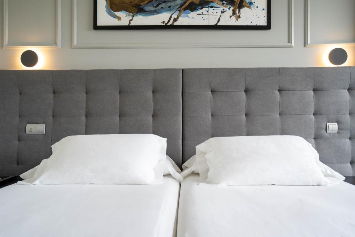 Cama o camas de una habitación en Abba Comillas Hotel