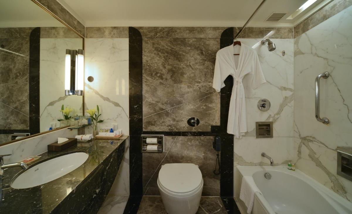a bathroom with a sink and a toilet and a tub at Hotel Marine Plaza in Mumbai a bathroom with a sink and a toilet and a tub at Hotel Marine Plaza in Mumbai
