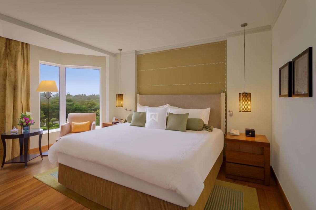 a bedroom with a large white bed and a window at ITC Maurya, a Luxury Collection Hotel, New Delhi in New Delhi a bedroom with a large white bed and a window at ITC Maurya, a Luxury Collection Hotel, New Delhi in New Delhi