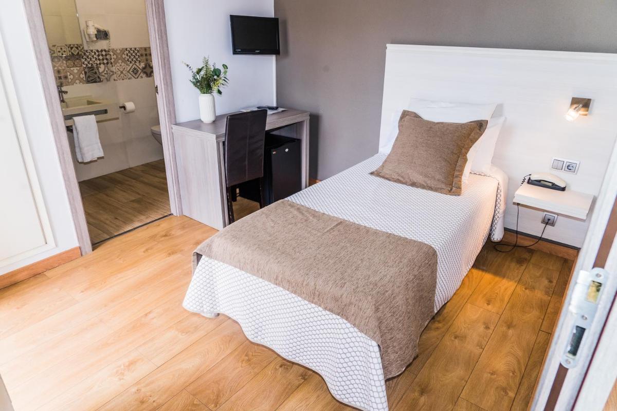 Cama o camas de una habitación en Hotel Planas