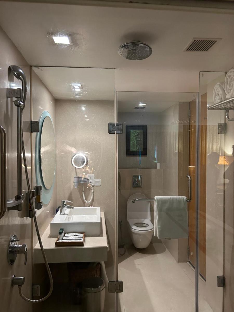 a bathroom with a sink and a toilet and a shower at Fortune Select SG Highway, Ahmedabad - Member ITC Hotels' Group in Ahmedabad
