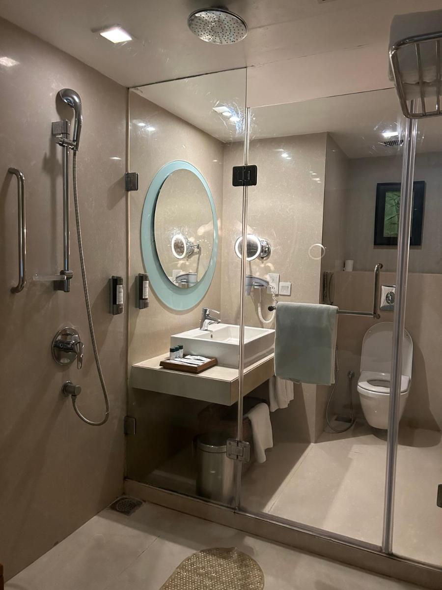 a bathroom with a shower and a sink and a toilet at Fortune Select SG Highway, Ahmedabad - Member ITC Hotels' Group in Ahmedabad