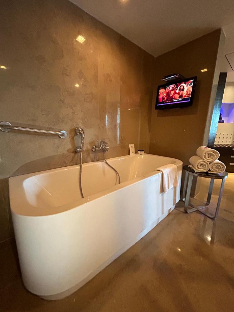 a bath tub in a bathroom with a tv at Fortune Select SG Highway, Ahmedabad - Member ITC Hotels' Group in Ahmedabad