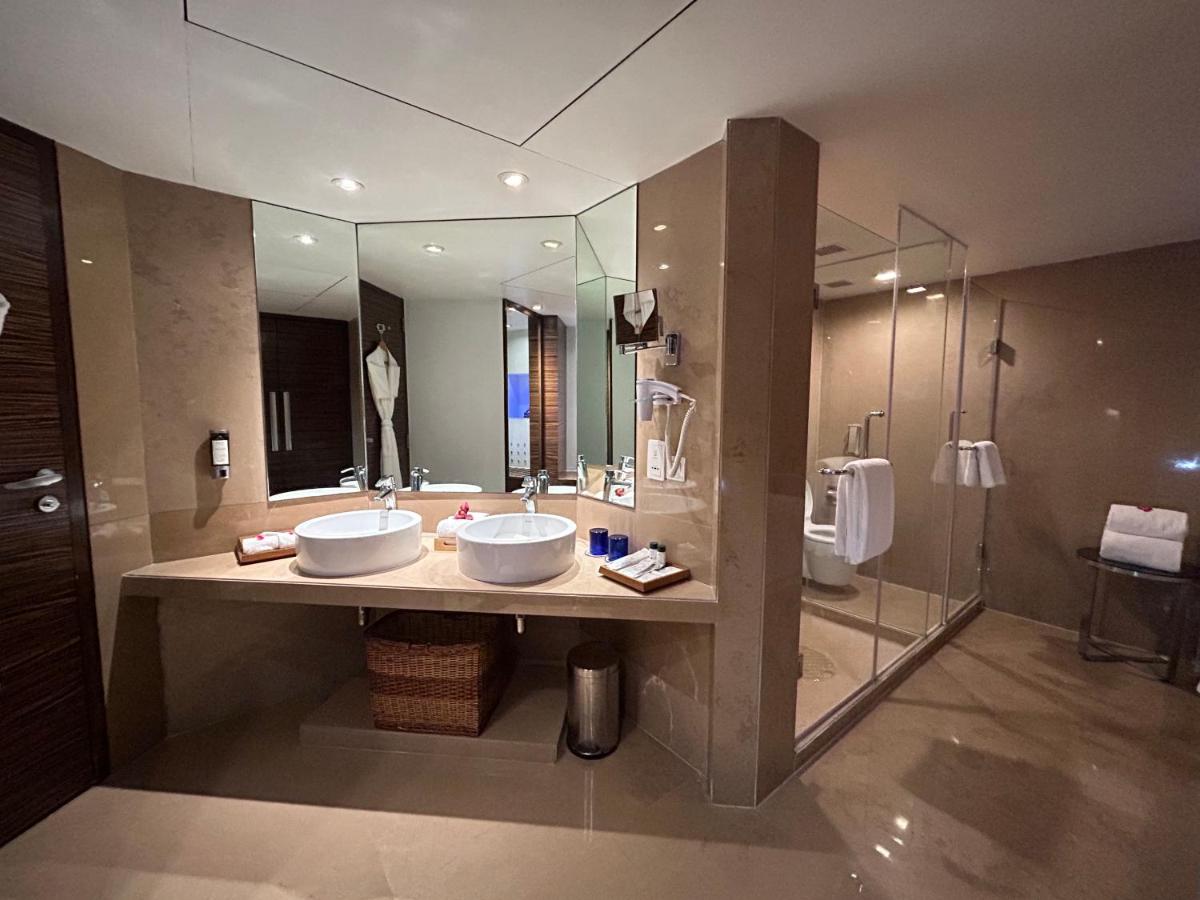 a bathroom with two sinks and a large mirror at Fortune Select SG Highway, Ahmedabad - Member ITC Hotels' Group in Ahmedabad