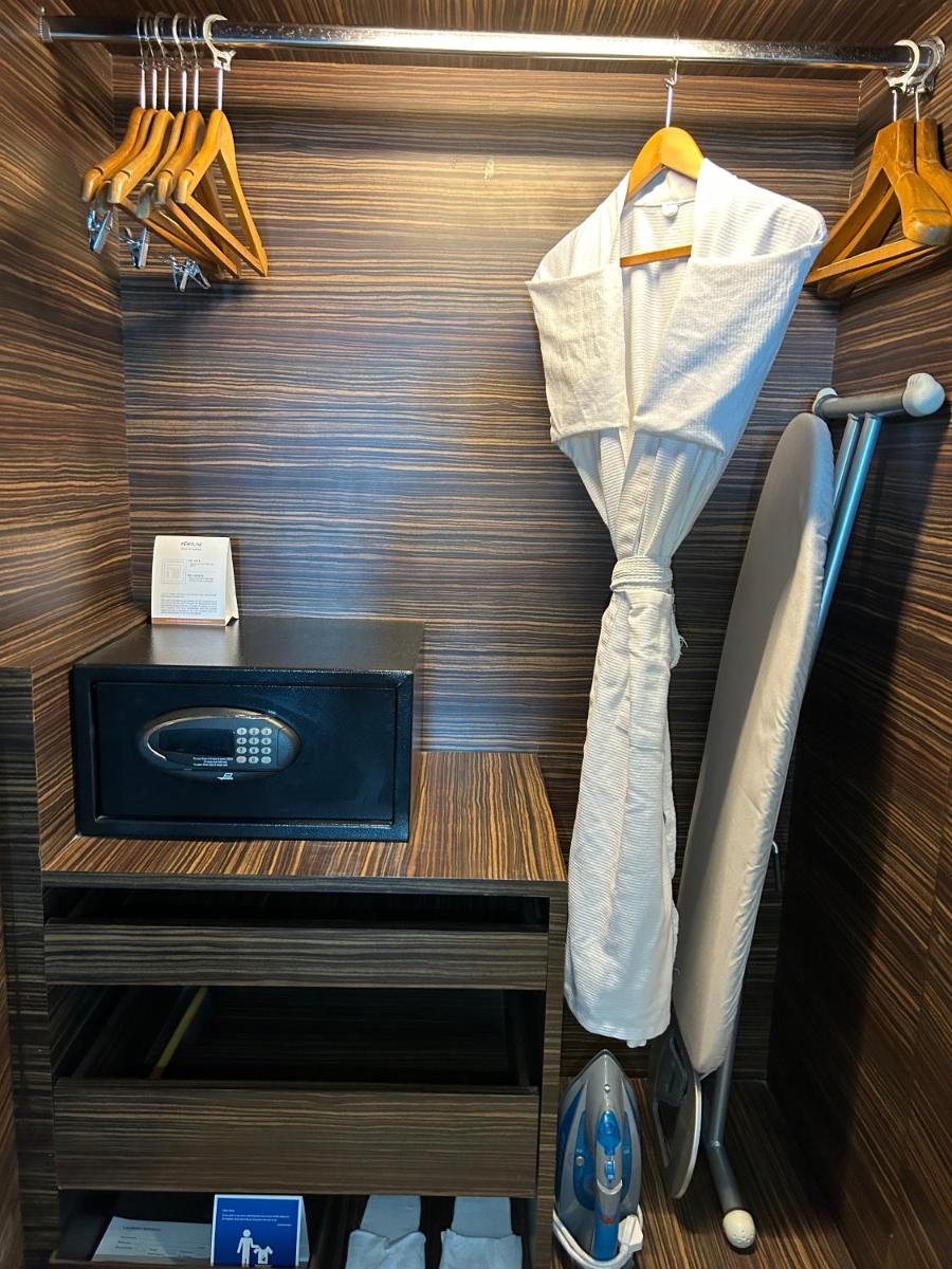 a dressing room with a bed and a table with a drawer at Fortune Select SG Highway, Ahmedabad - Member ITC Hotels' Group in Ahmedabad