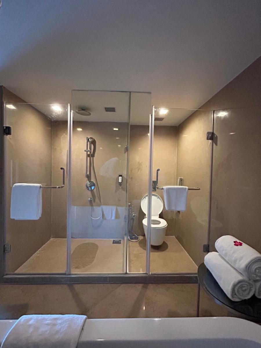 a bathroom with a glass shower and a toilet at Fortune Select SG Highway, Ahmedabad - Member ITC Hotels' Group in Ahmedabad