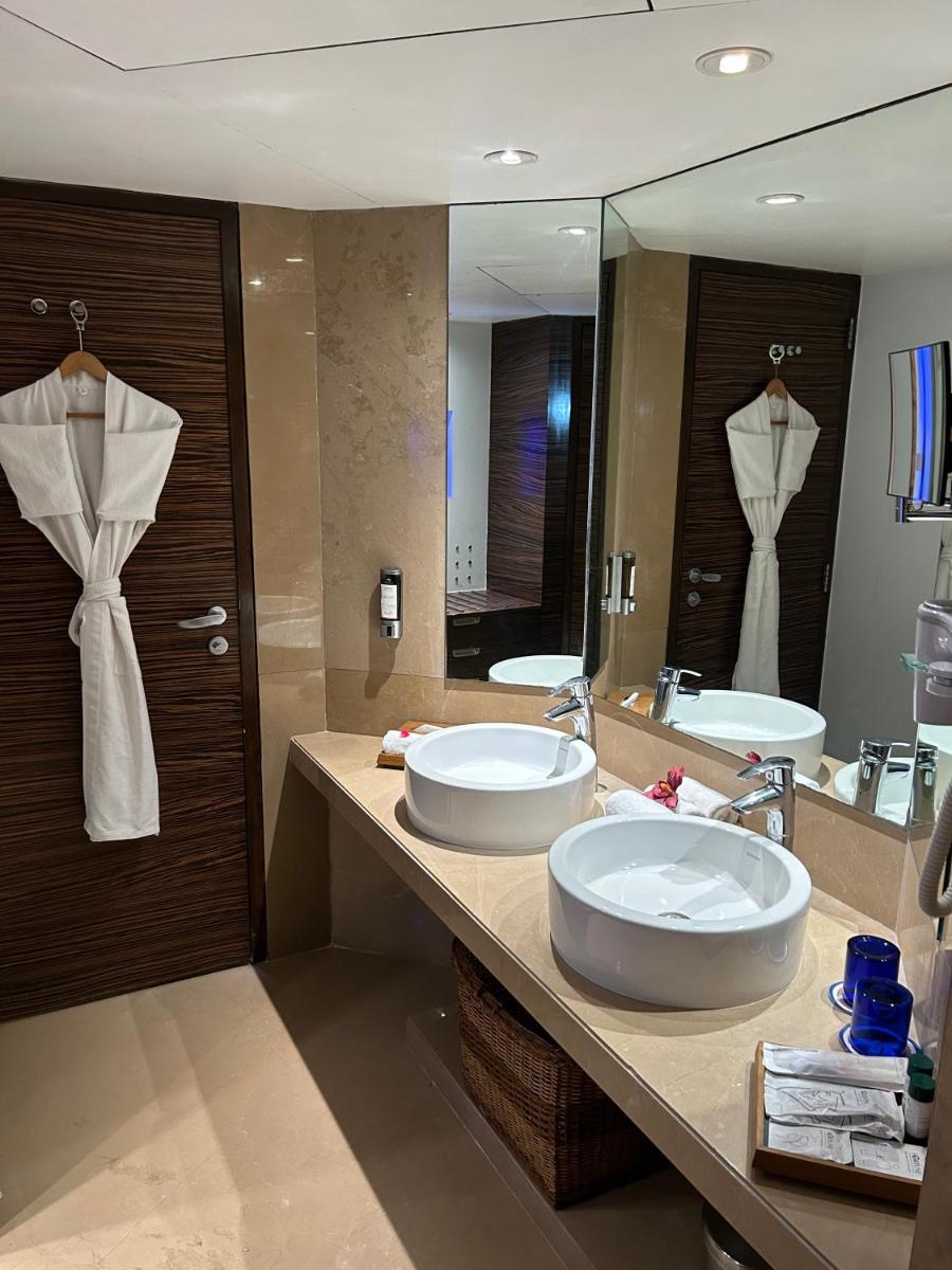 a bathroom with two sinks and a large mirror at Fortune Select SG Highway, Ahmedabad - Member ITC Hotels' Group in Ahmedabad