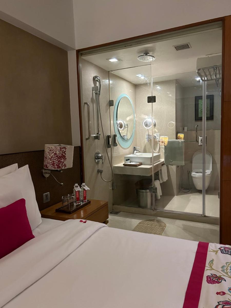 a bedroom with a large bed and a bathroom at Fortune Select SG Highway, Ahmedabad - Member ITC Hotels' Group in Ahmedabad