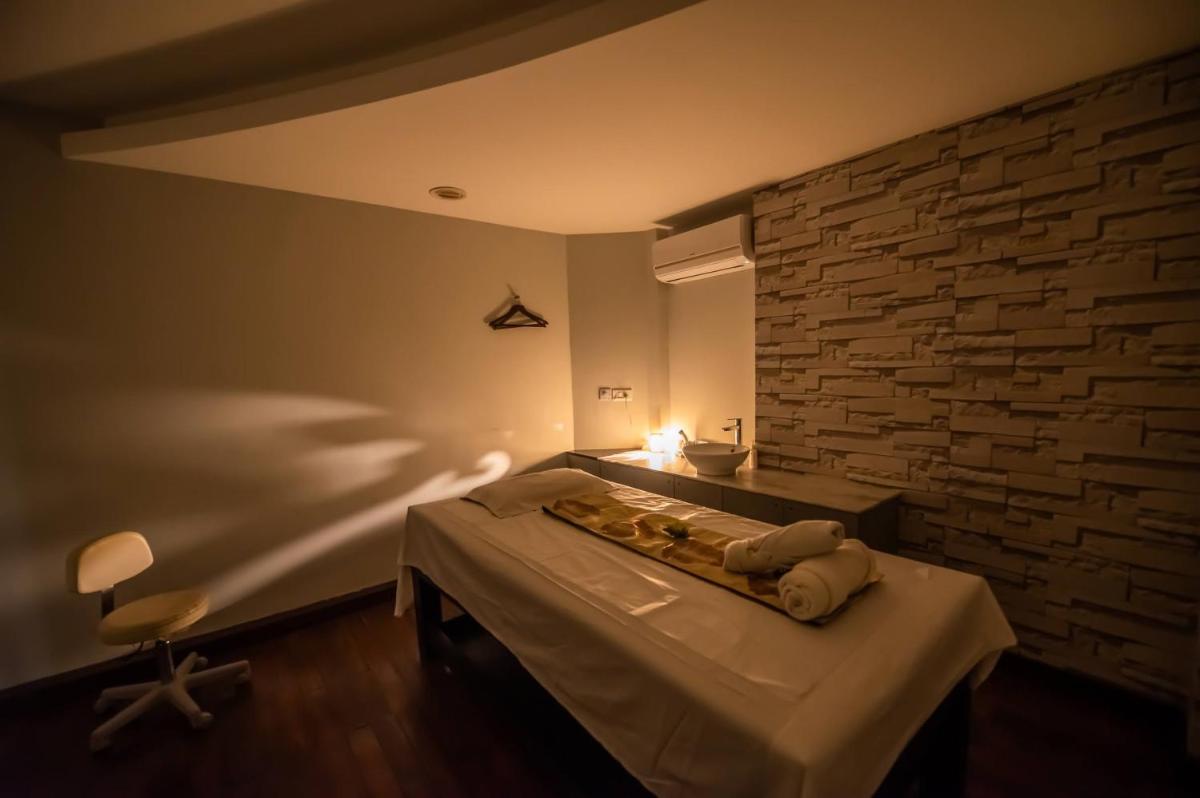 a room with a bed and a brick wall at O Hotel Pune in Pune