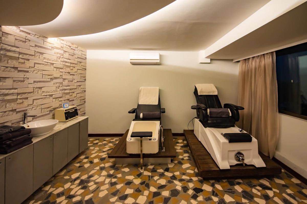 a hospital room with two chairs and a sink at O Hotel Pune in Pune