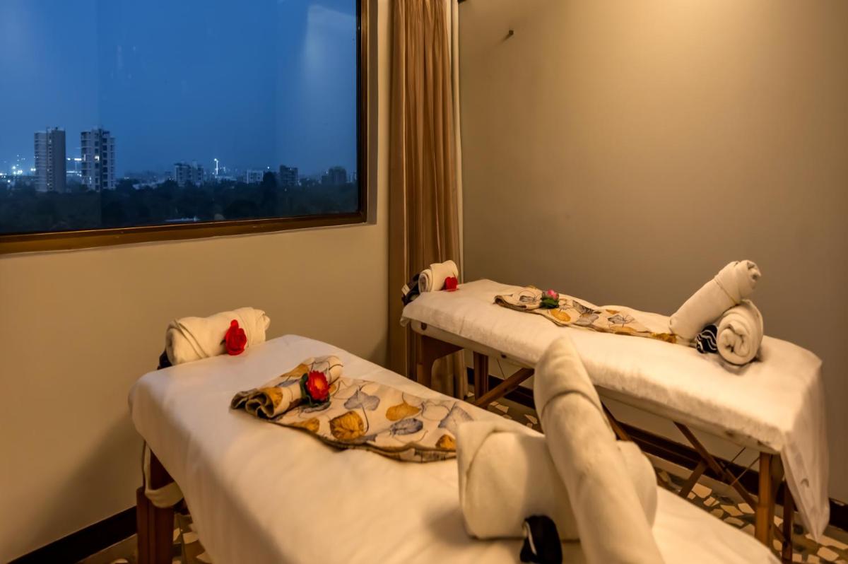 a hospital room with two beds and a window at O Hotel Pune in Pune