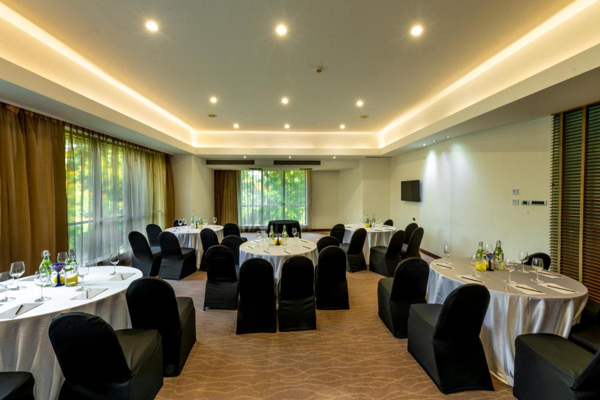 a conference room with tables and chairs in it at O Hotel Pune in Pune