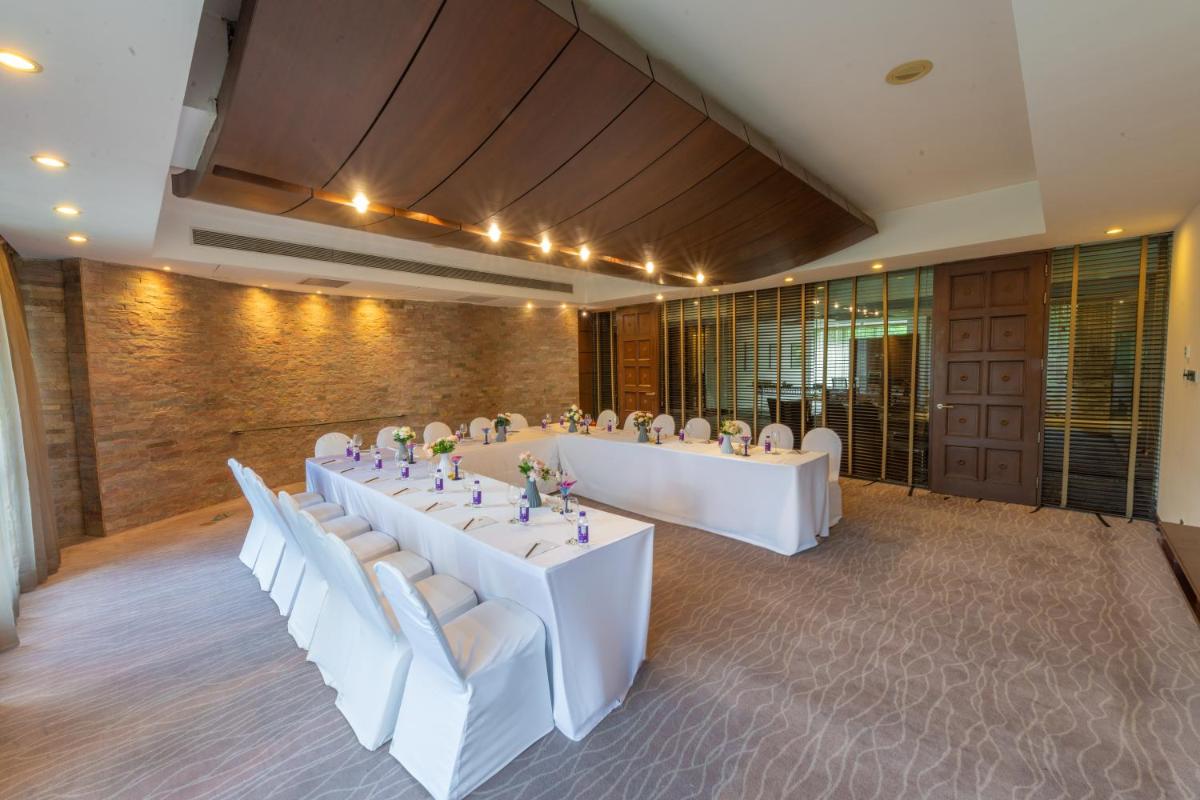 a meeting room with white tables and white chairs at O Hotel Pune in Pune