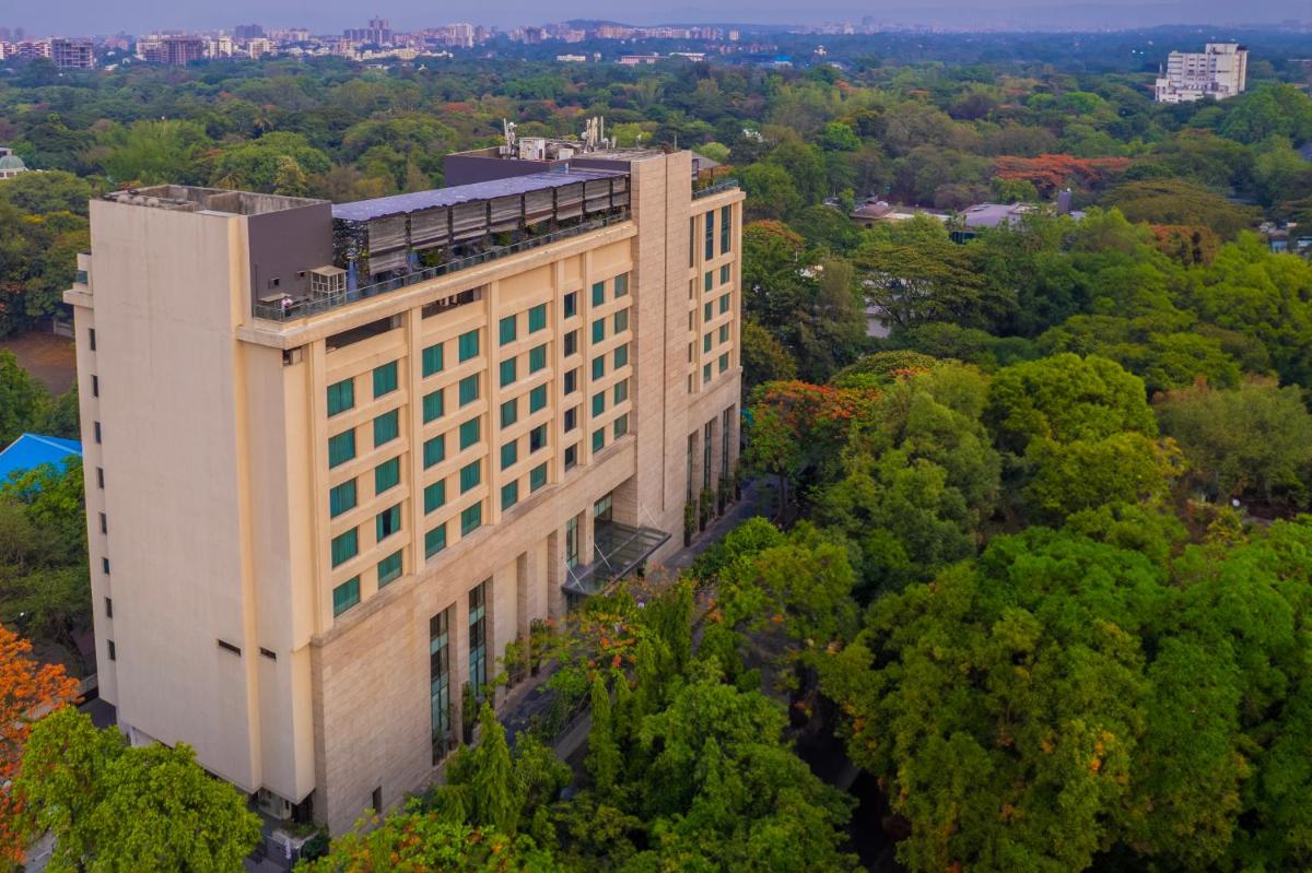 an overhead view of a tall building with trees at O Hotel Pune in Pune
