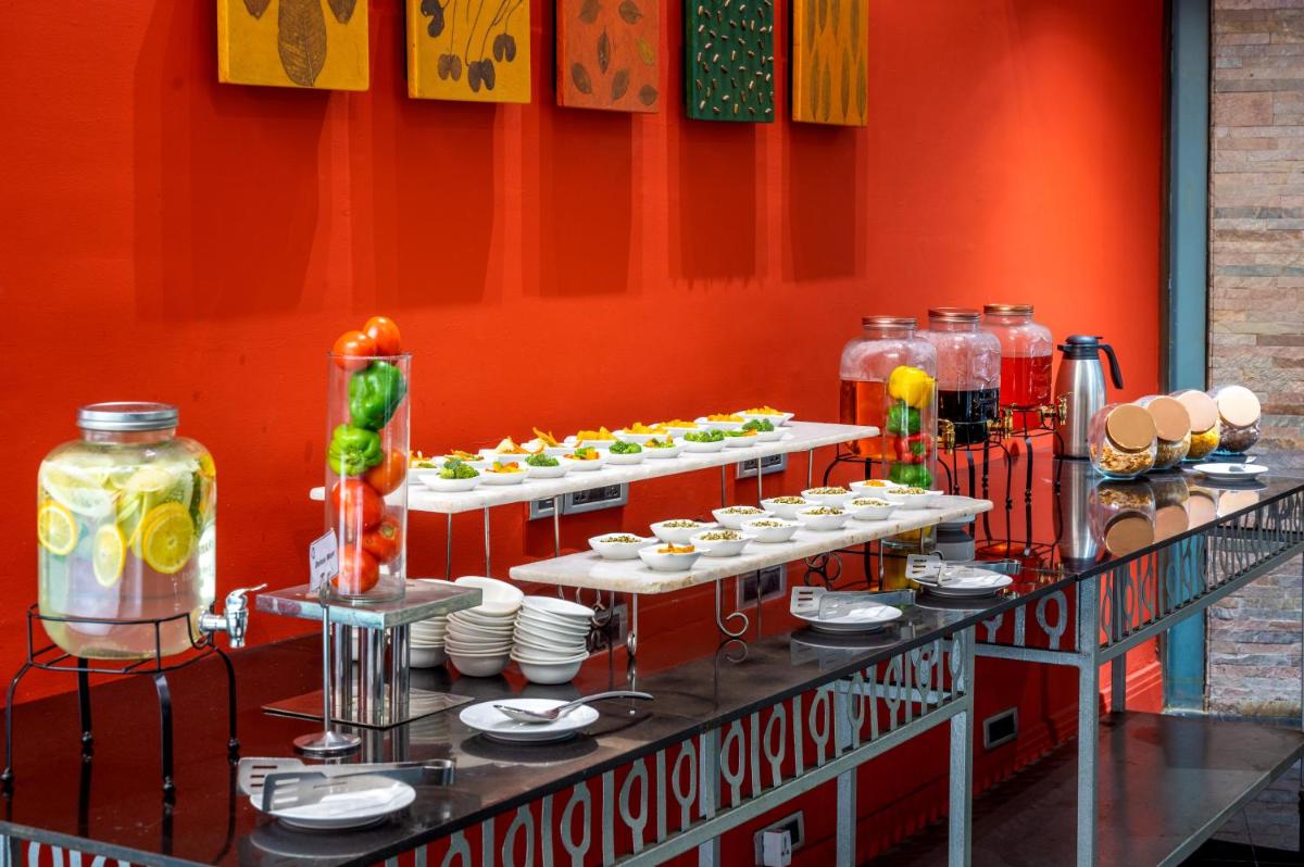 a buffet of food on a table in a room at O Hotel Pune in Pune