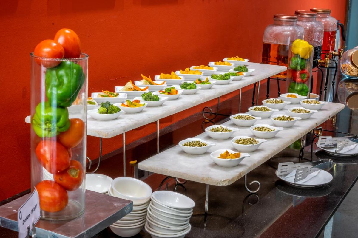 a buffet line with plates of food and appetizers at O Hotel Pune in Pune