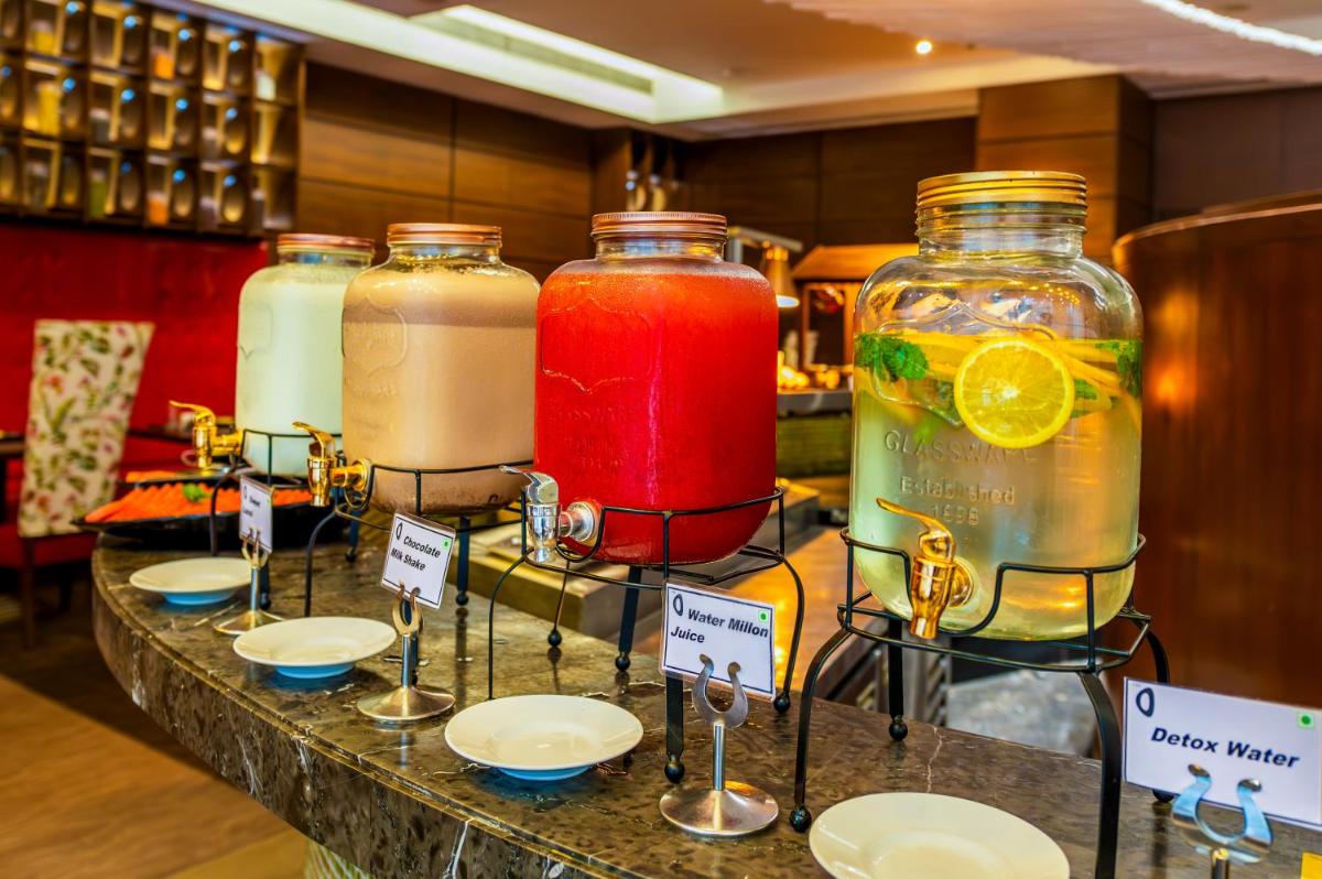 a display of drinks in jars on a table at O Hotel Pune in Pune