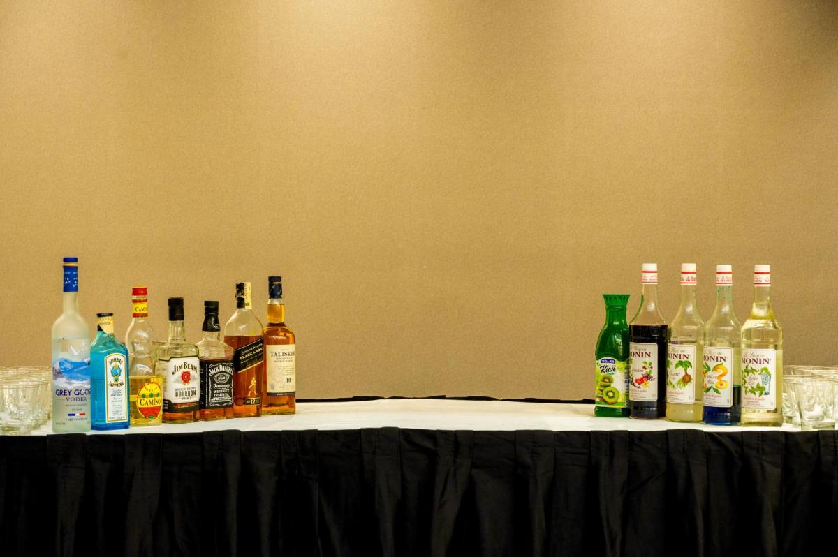 a group of bottles of alcohol sitting on a table at O Hotel Pune in Pune