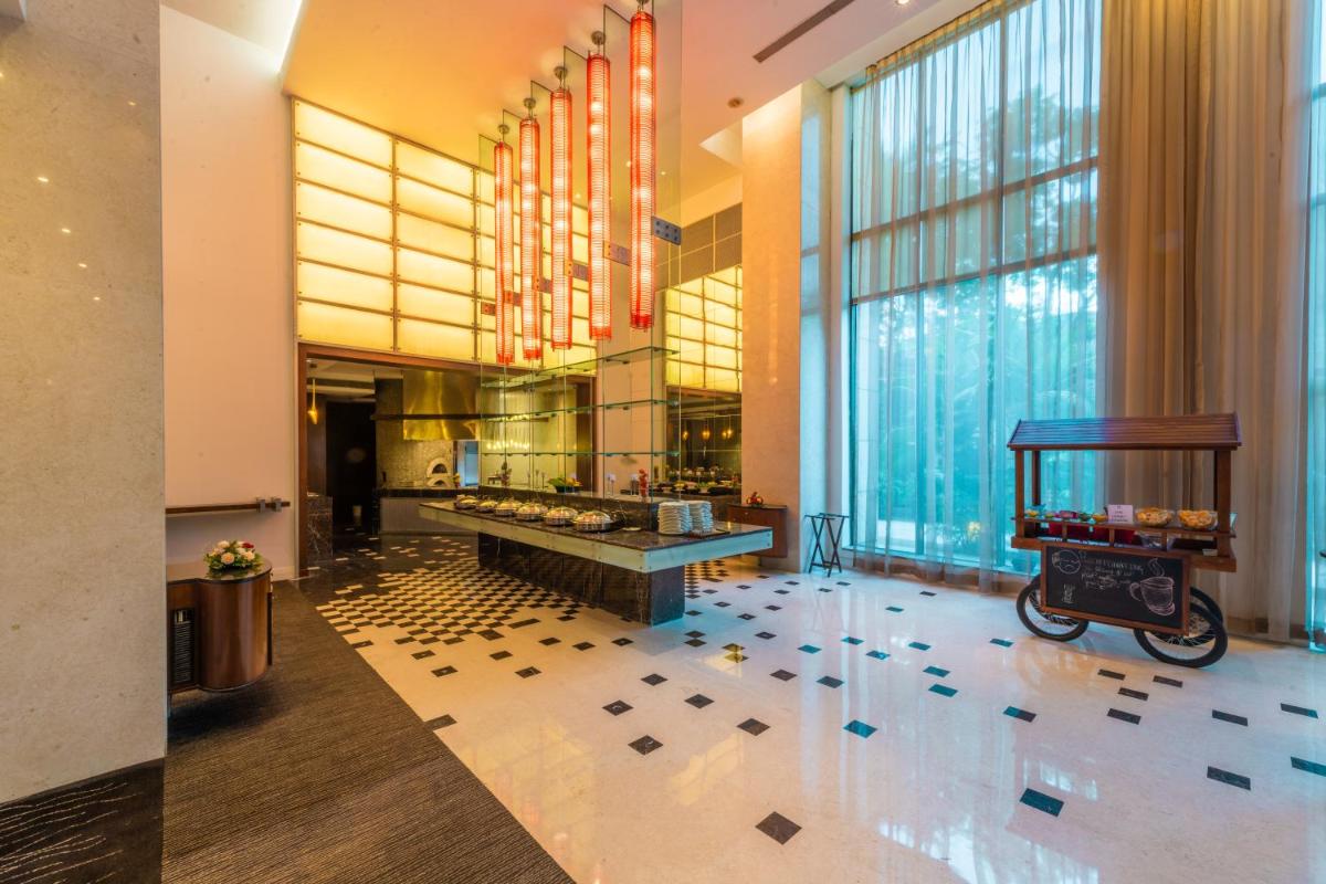 a lobby with a scooter in the middle of a building at O Hotel Pune in Pune