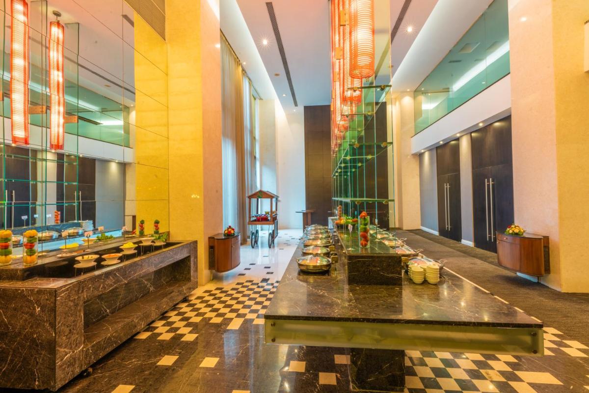 a lobby with a long table in a building at O Hotel Pune in Pune