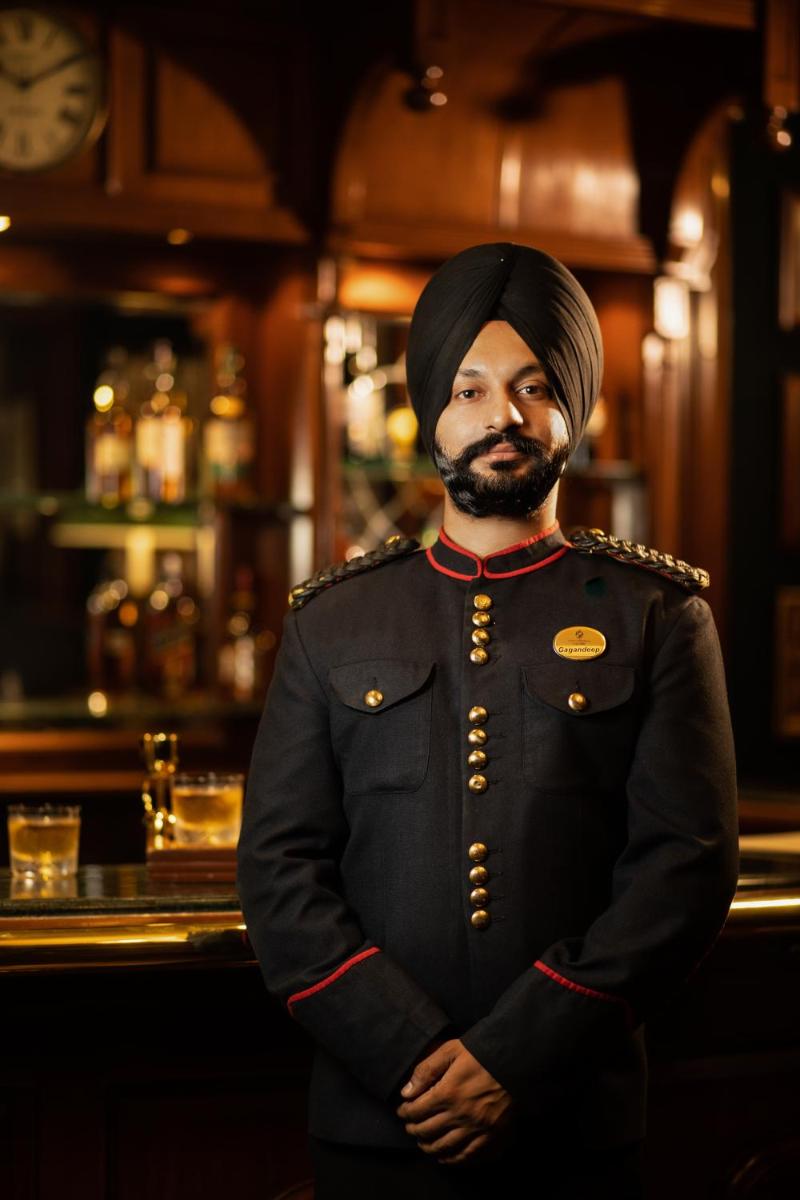 a man in uniform standing in front of a bar at The Imperial, New Delhi in New Delhi a man in uniform standing in front of a bar at The Imperial, New Delhi in New Delhi