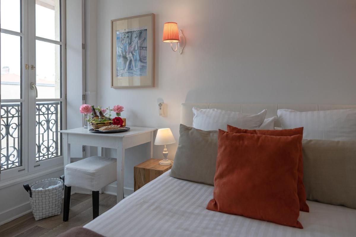 Un ou plusieurs lits dans un hébergement de l'établissement Hôtel & Espace Bien-être La Maison du Lierre