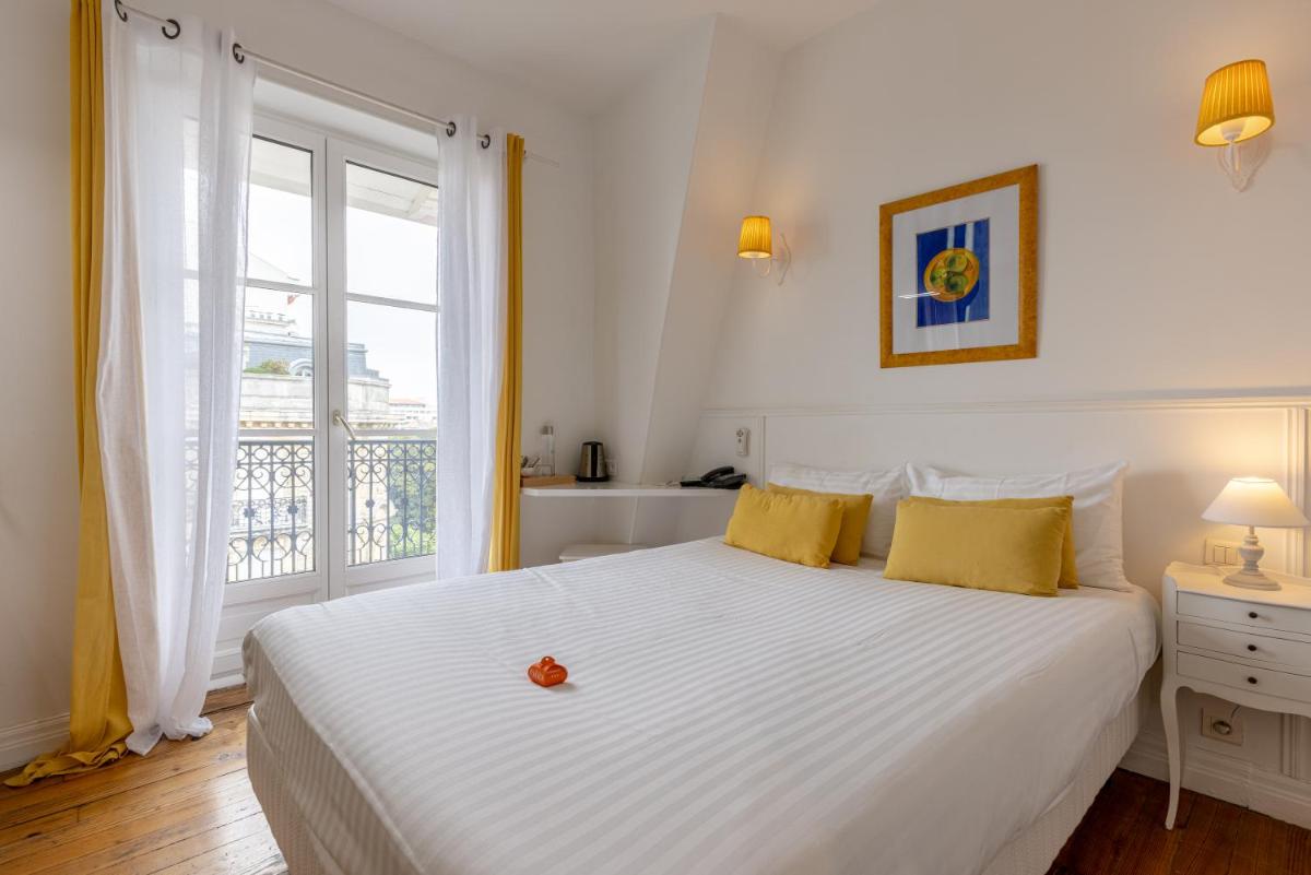 Un ou plusieurs lits dans un hébergement de l'établissement Hôtel & Espace Bien-être La Maison du Lierre
