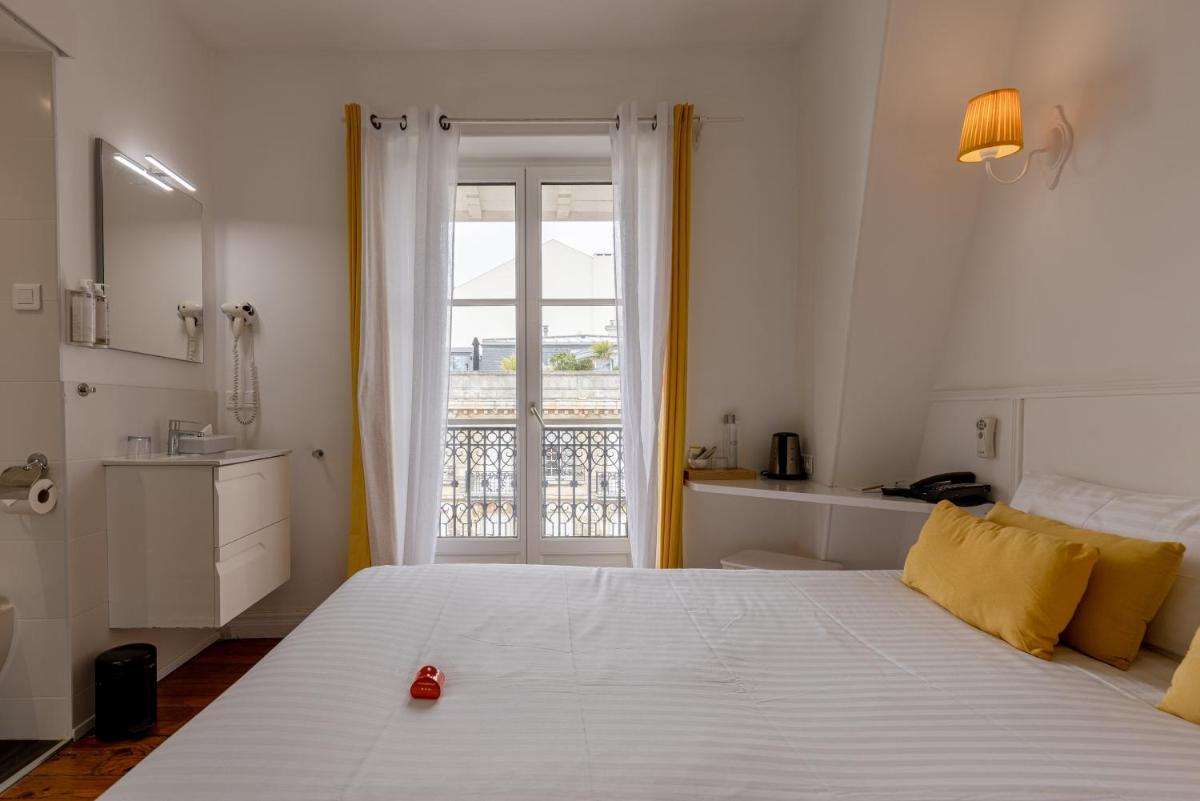 Un ou plusieurs lits dans un hébergement de l'établissement Hôtel & Espace Bien-être La Maison du Lierre