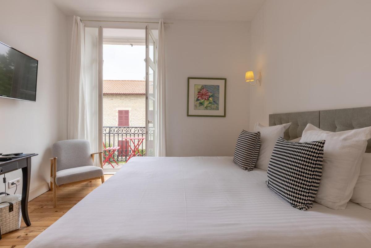 Un ou plusieurs lits dans un hébergement de l'établissement Hôtel & Espace Bien-être La Maison du Lierre