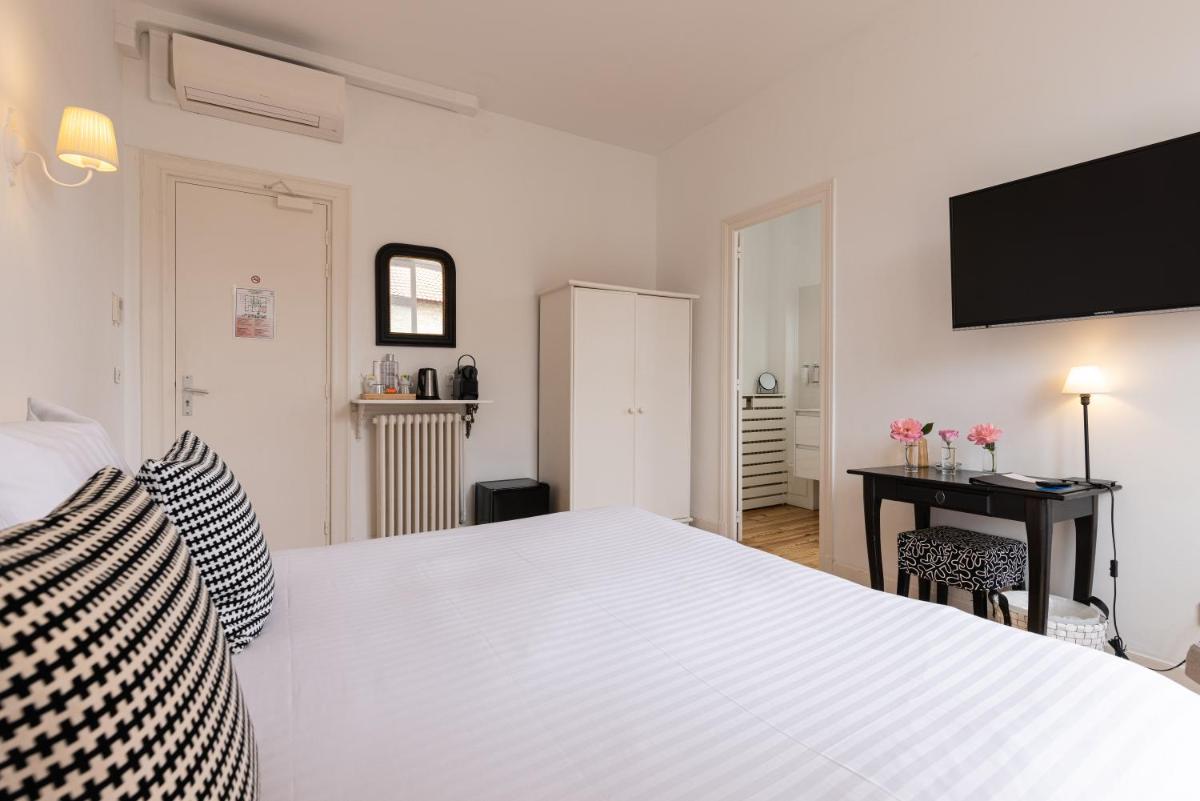 Un ou plusieurs lits dans un hébergement de l'établissement Hôtel & Espace Bien-être La Maison du Lierre