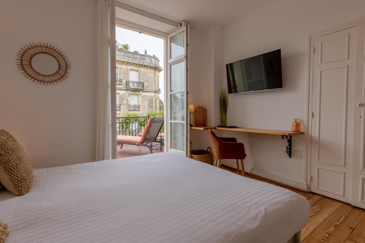 Un ou plusieurs lits dans un hébergement de l'établissement Hôtel & Espace Bien-être La Maison du Lierre