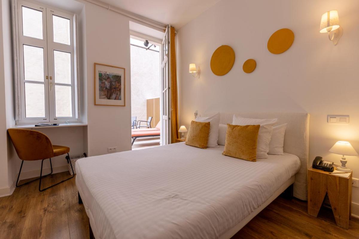 Un ou plusieurs lits dans un hébergement de l'établissement Hôtel & Espace Bien-être La Maison du Lierre