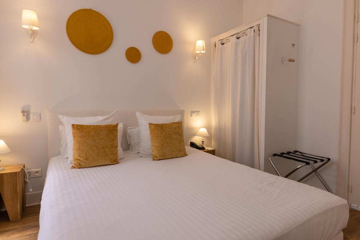 Un ou plusieurs lits dans un hébergement de l'établissement Hôtel & Espace Bien-être La Maison du Lierre