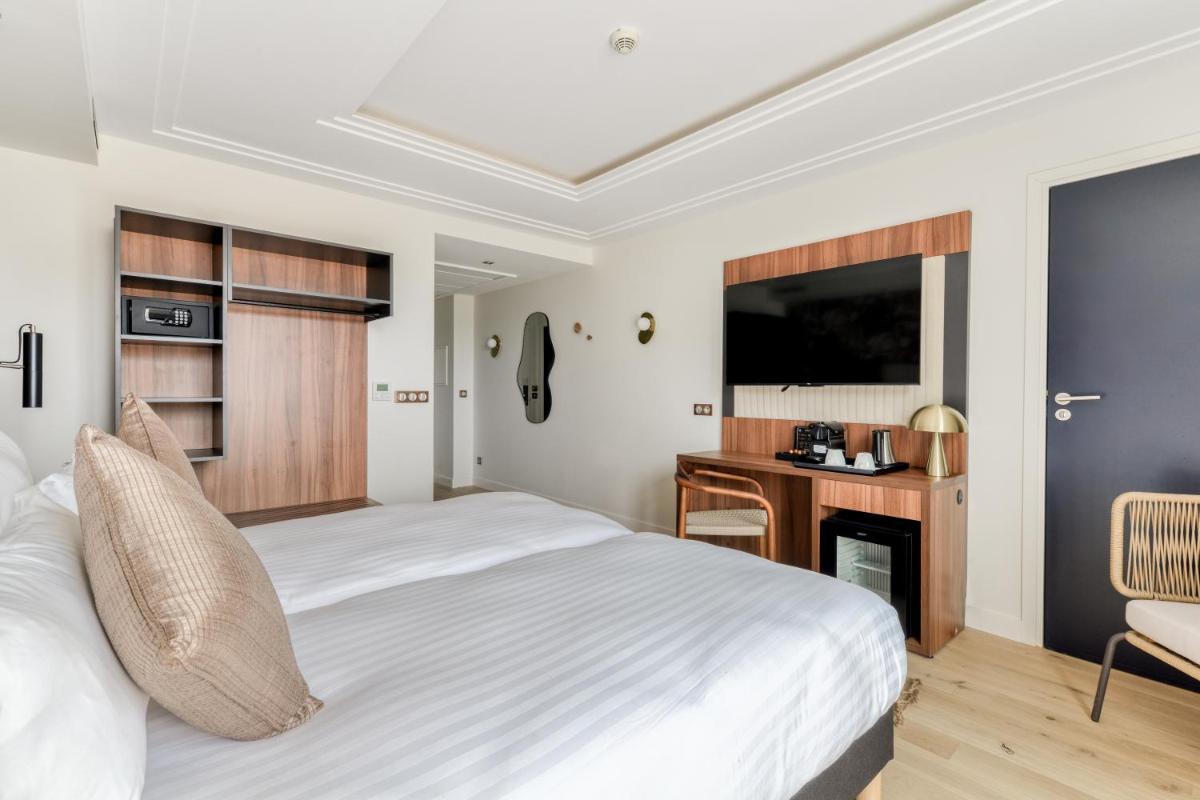 Un ou plusieurs lits dans un hébergement de l'établissement Zenitude Hotel La Valadière, Ascend Hotel Collection