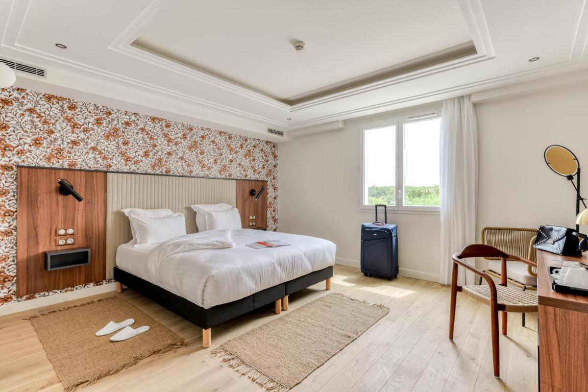 Un ou plusieurs lits dans un hébergement de l'établissement Zenitude Hotel La Valadière, Ascend Hotel Collection