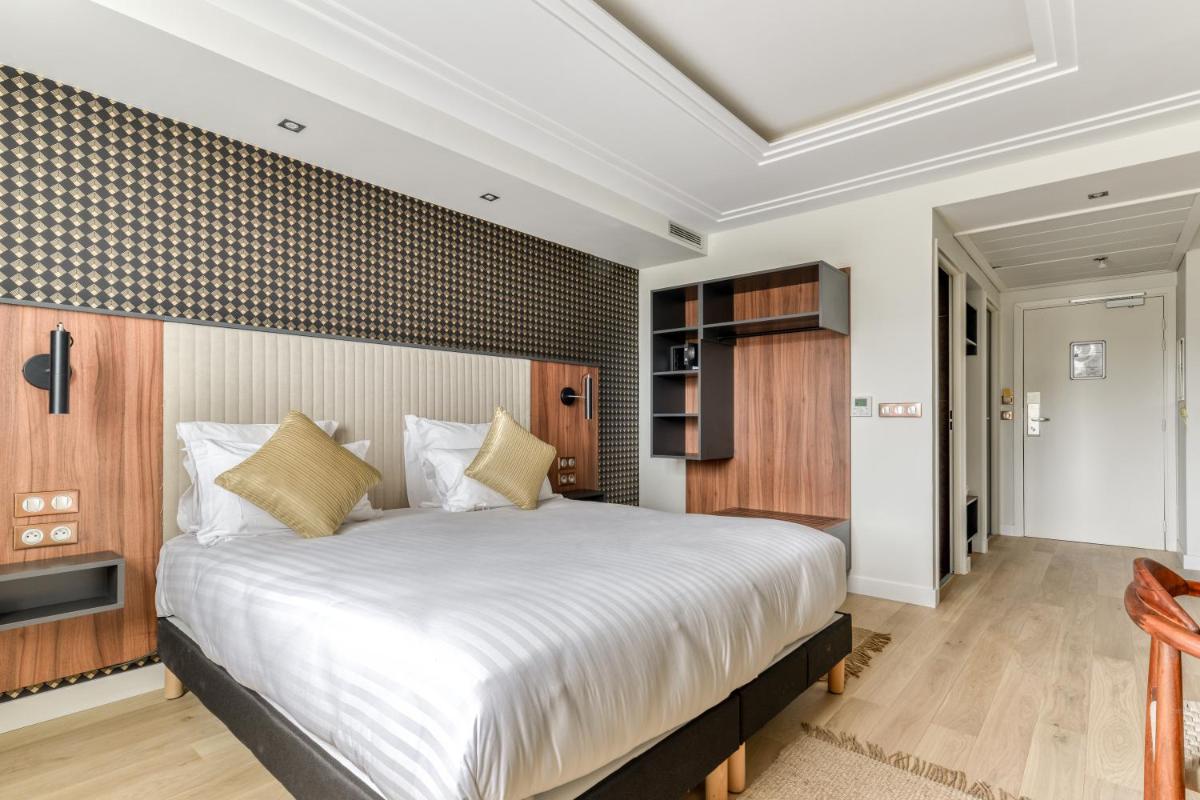 Un ou plusieurs lits dans un hébergement de l'établissement Zenitude Hotel La Valadière, Ascend Hotel Collection