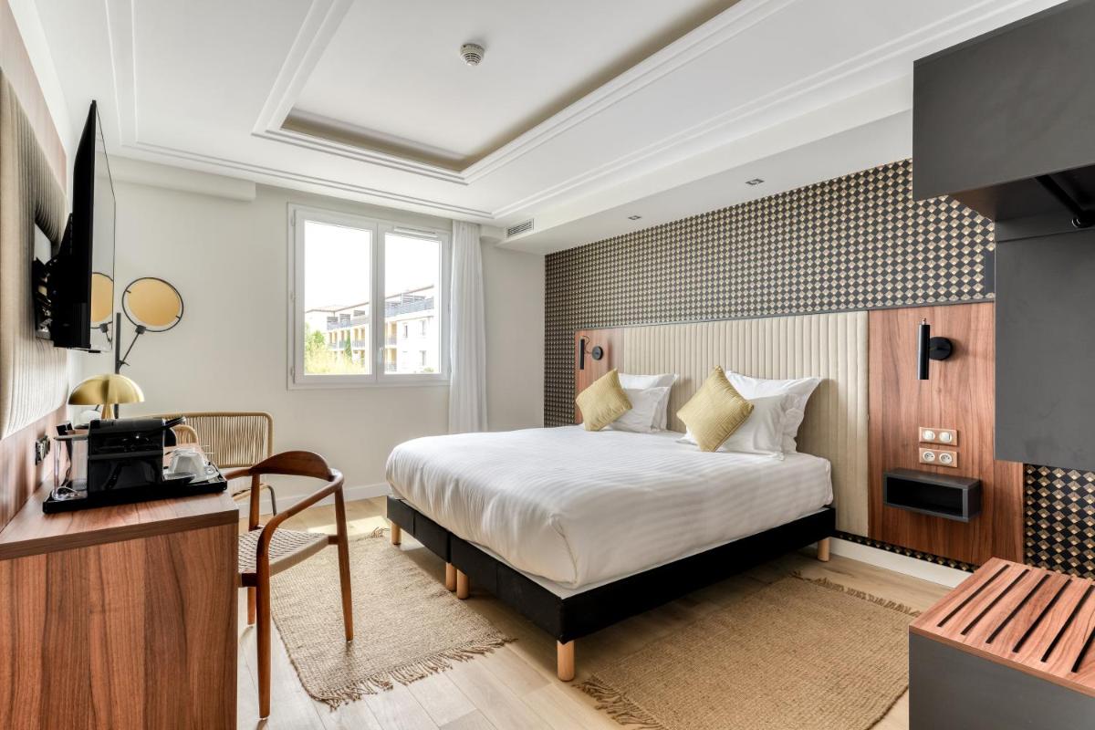 Un ou plusieurs lits dans un hébergement de l'établissement Zenitude Hotel La Valadière, Ascend Hotel Collection