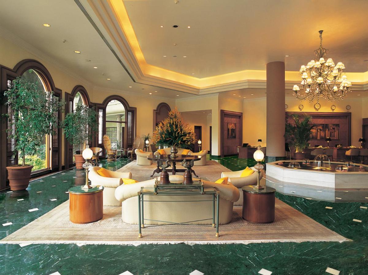 a lobby with couches and tables and a chandelier at The Oberoi Bengaluru in Bengaluru a lobby with couches and tables and a chandelier at The Oberoi Bengaluru in Bengaluru
