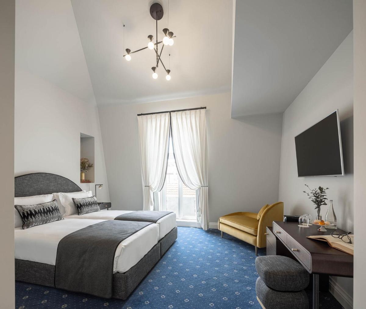Uma cama ou camas num quarto em MS Collection Aveiro - Palacete Valdemouro