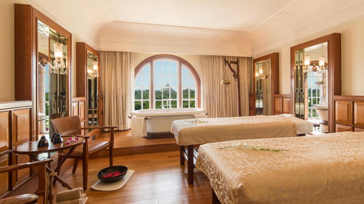 a hotel room with two beds and a tub at The Oberoi Amarvilas Agra in Agra